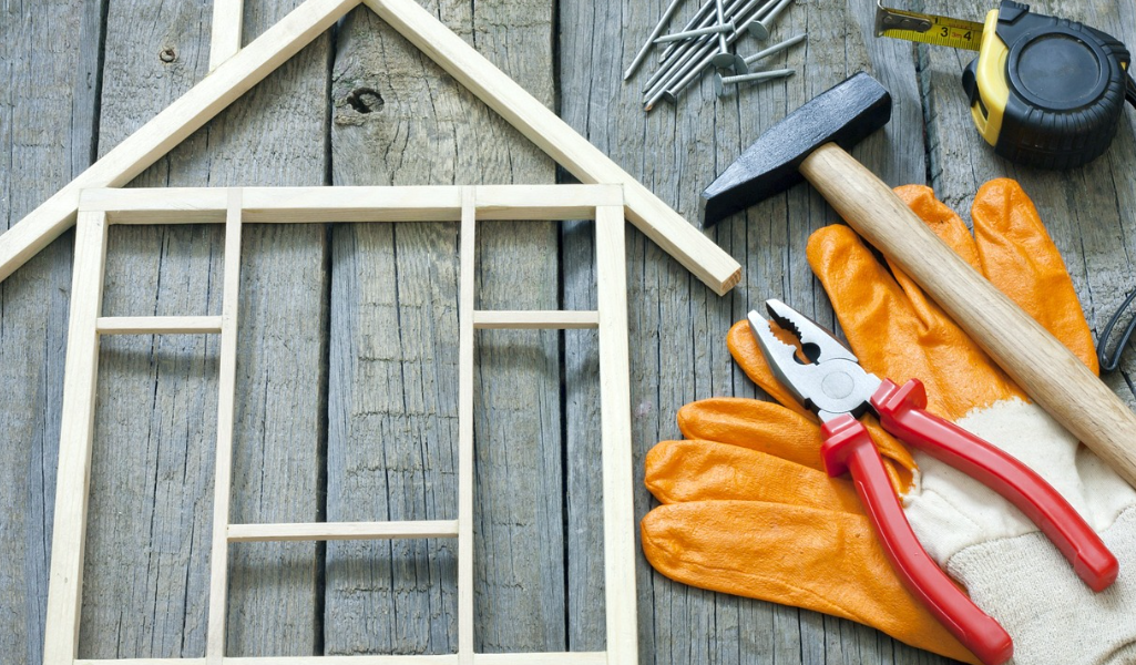 wooden house, pliers on a table to show home addition renovation