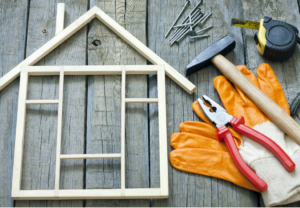 wooden house, pliers on a table to show home addition renovation