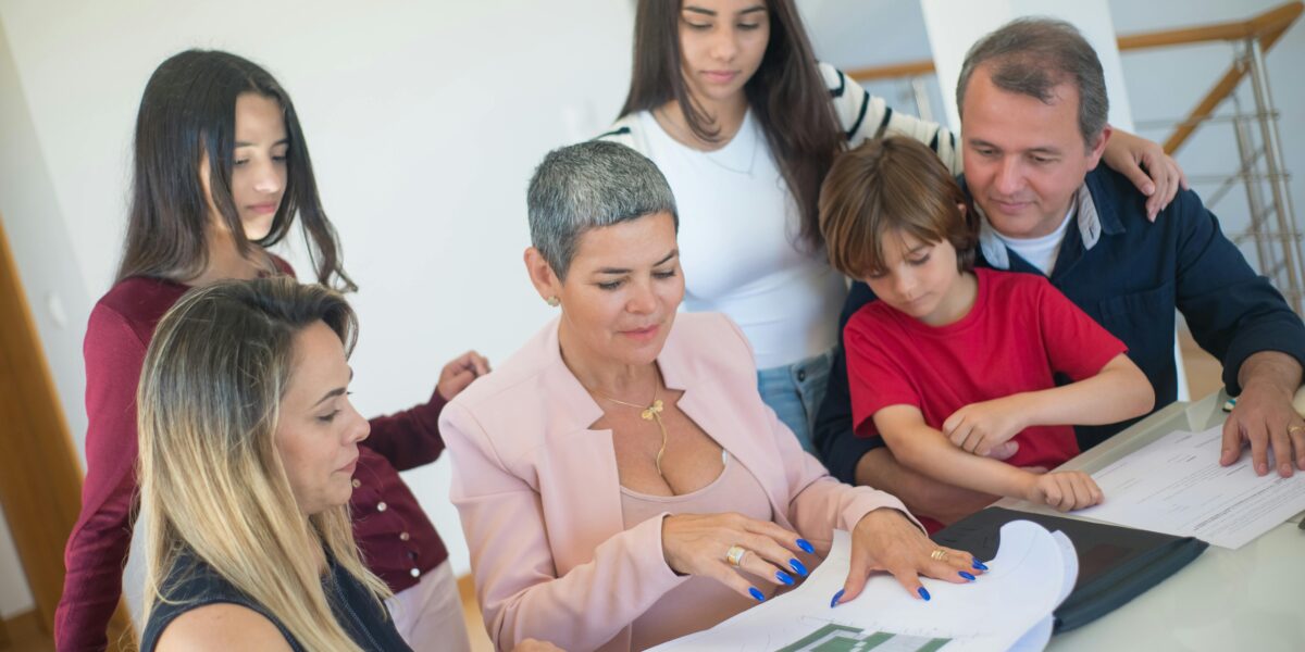Family look over home addition blueprint in Toronto home